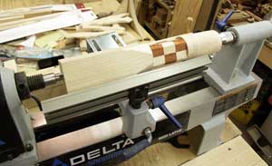The rocket blank mounted on the lathe and partially turned.